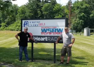Travis and Dean in front of WSRW sign